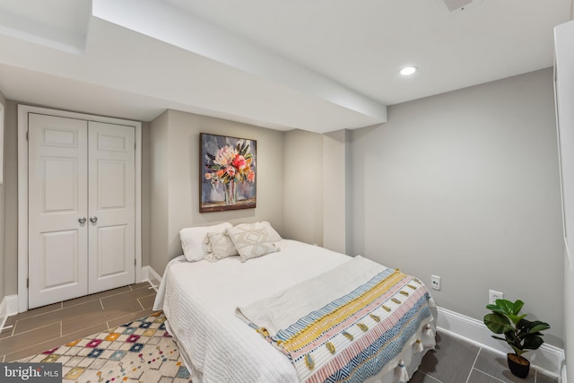 bedroom featuring a closet and dark tile patterned flooring