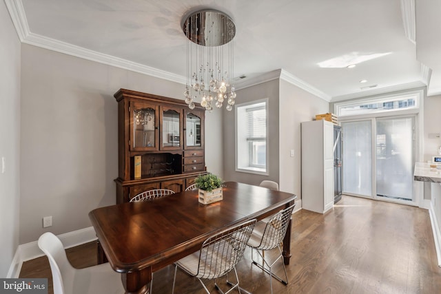 dining space featuring a chandelier, crown molding, and dark hardwood / wood-style flooring