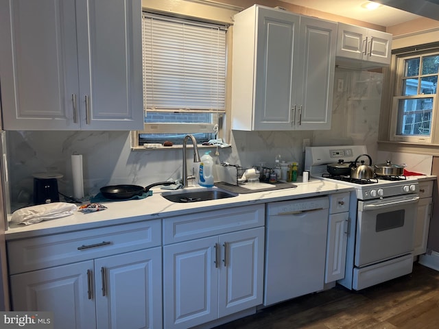 kitchen with white cabinets, sink, white appliances, backsplash, and dark hardwood / wood-style flooring