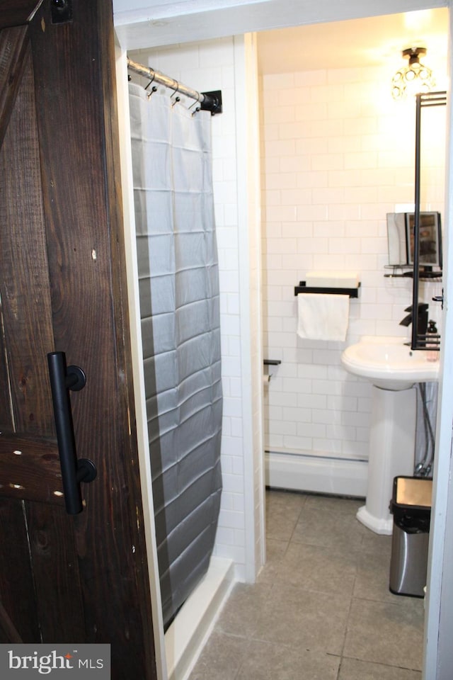 bathroom featuring tile patterned floors, a baseboard heating unit, and a shower with shower curtain