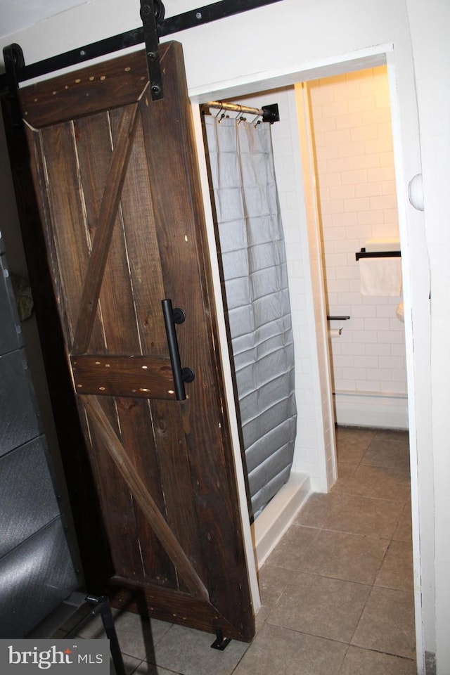 bathroom with tile patterned floors and walk in shower