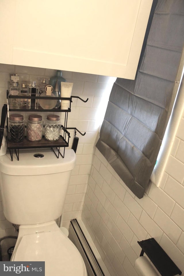 bathroom with toilet, tile walls, a baseboard radiator, and backsplash