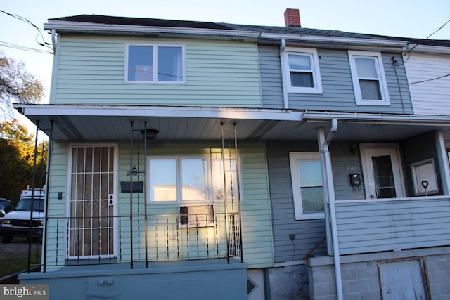 view of property featuring covered porch