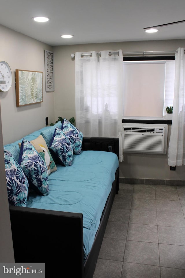 bedroom with cooling unit, multiple windows, and tile patterned flooring