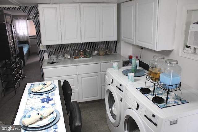 washroom featuring dark tile patterned floors and washer and clothes dryer