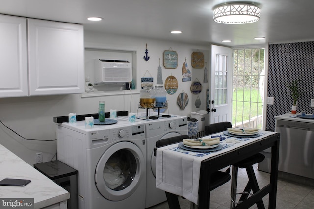 laundry room with washer and clothes dryer and light tile patterned floors