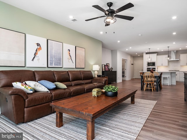 living room featuring ceiling fan and wood-type flooring