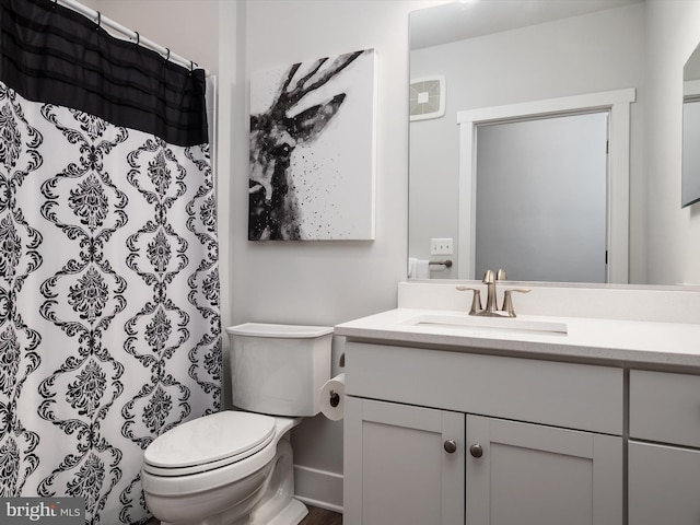 bathroom with vanity, toilet, and curtained shower