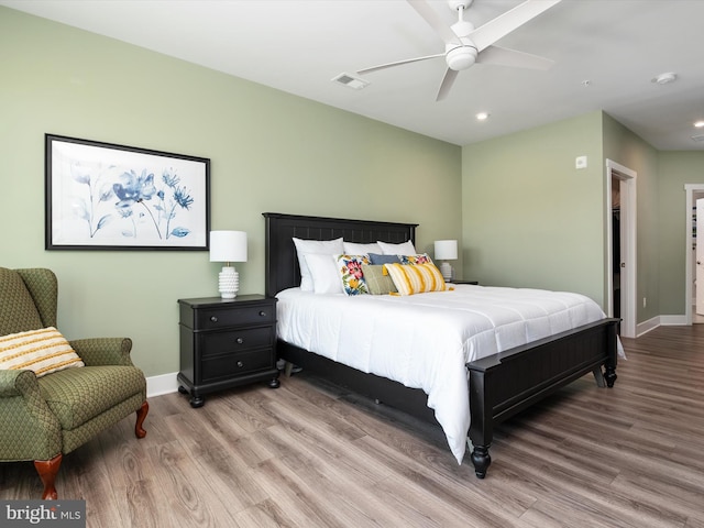 bedroom with ceiling fan and light hardwood / wood-style floors