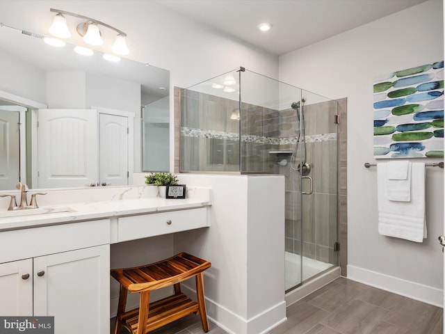 bathroom with vanity and a shower with door