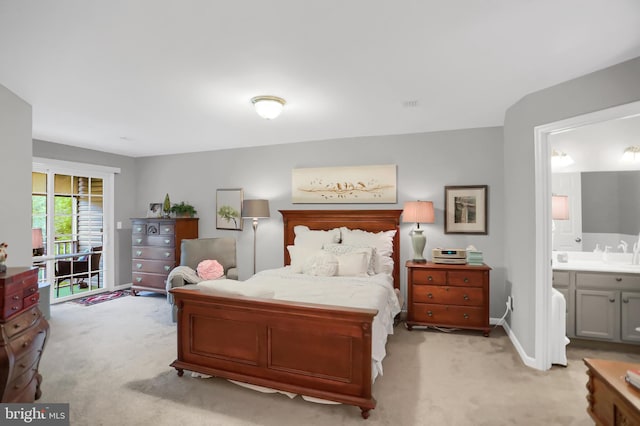 bedroom featuring light carpet and ensuite bathroom