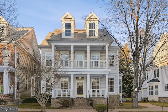 view of front facade with a balcony and covered porch