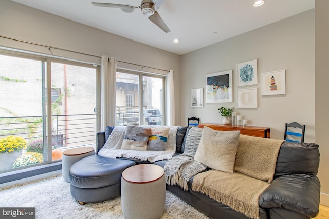 living room featuring ceiling fan, plenty of natural light, and hardwood / wood-style floors