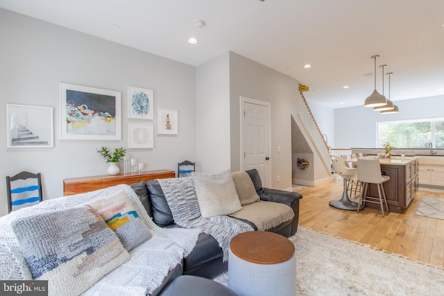 living room featuring light hardwood / wood-style floors and sink