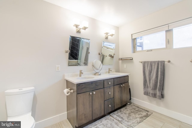 bathroom featuring toilet and vanity