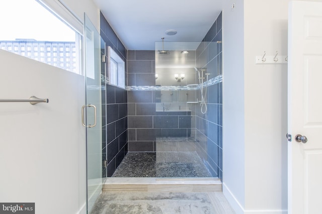 bathroom featuring hardwood / wood-style floors and a shower with shower door