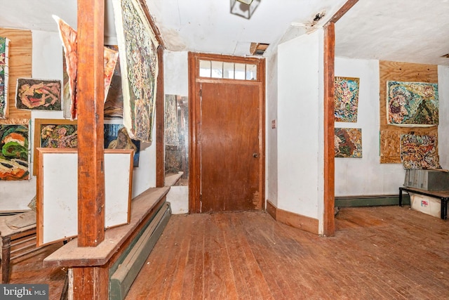 entrance foyer with hardwood / wood-style floors and a baseboard heating unit