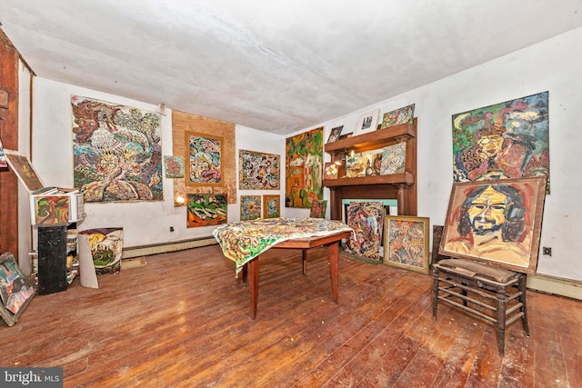 game room with hardwood / wood-style flooring and baseboard heating