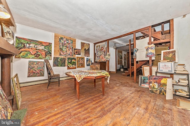 interior space featuring wood-type flooring and baseboard heating