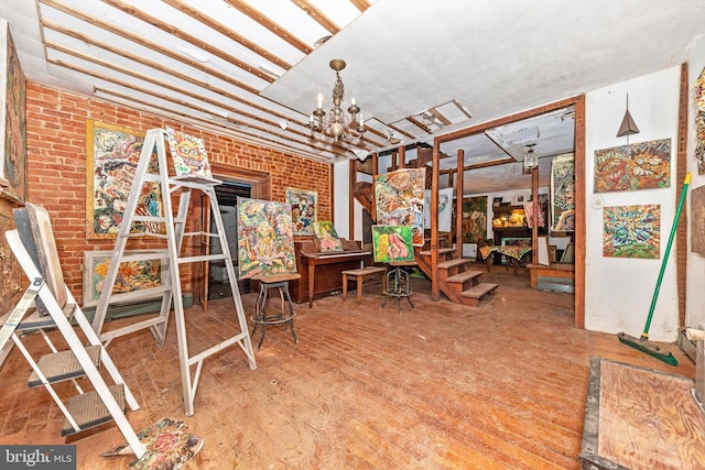 interior space featuring brick wall and an inviting chandelier