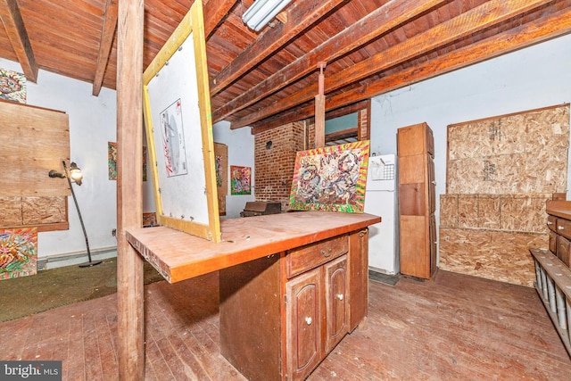 kitchen featuring butcher block countertops, beamed ceiling, white fridge, and wood ceiling