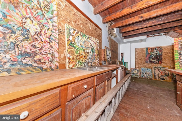 interior space with beamed ceiling, wooden ceiling, and sink