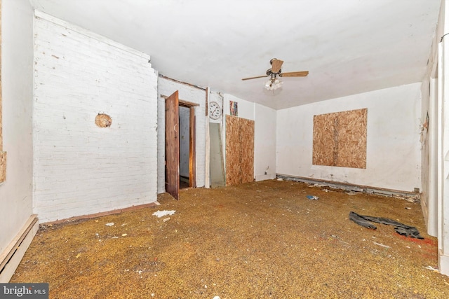6753 Dickerson Rd, Dickerson, MD 20842 - empty room with a baseboard heating unit, ceiling fan, and brick wall