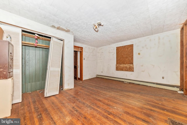 6753 Dickerson Rd, Dickerson, MD 20842 - unfurnished bedroom featuring hardwood / wood-style flooring, baseboard heating, and a closet