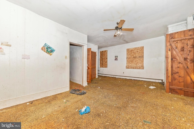 spare room featuring ceiling fan and a baseboard heating unit