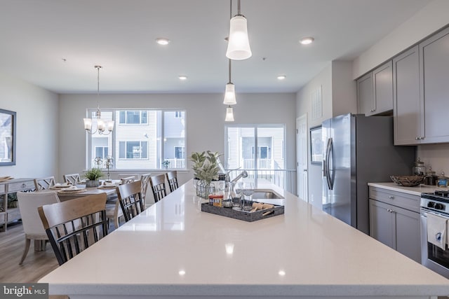 kitchen featuring a large island, a healthy amount of sunlight, and gray cabinetry