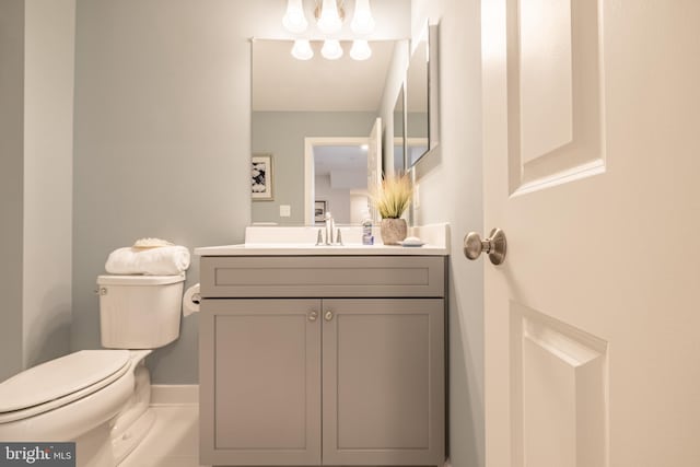 bathroom featuring vanity, toilet, and tile patterned flooring