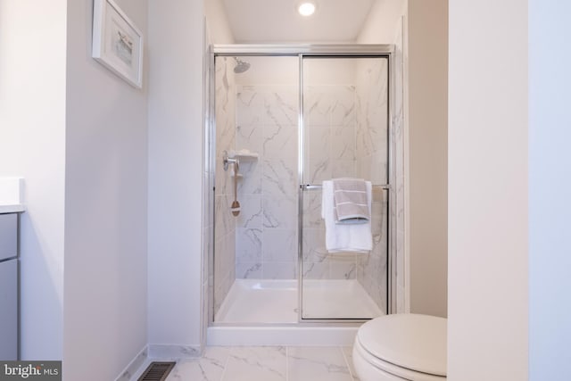 bathroom featuring vanity, toilet, and walk in shower