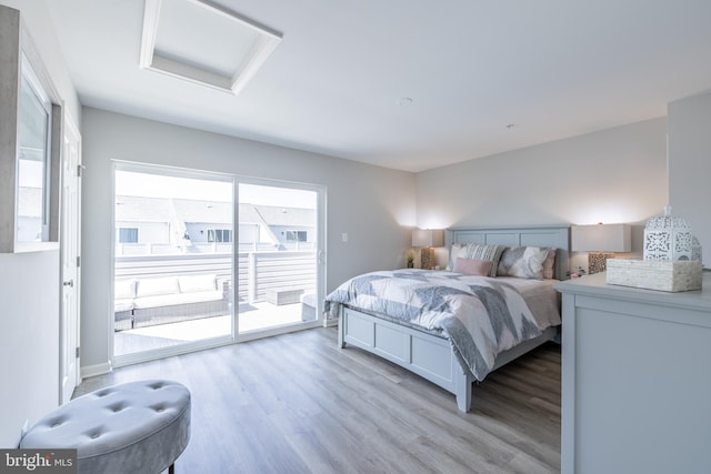 bedroom with light hardwood / wood-style flooring and access to exterior