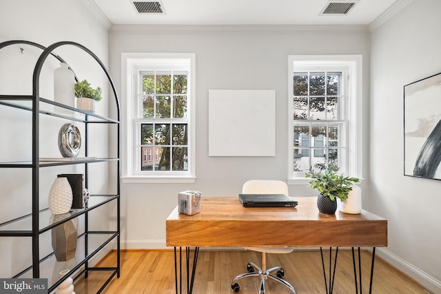 office area with light wood-type flooring and ornamental molding