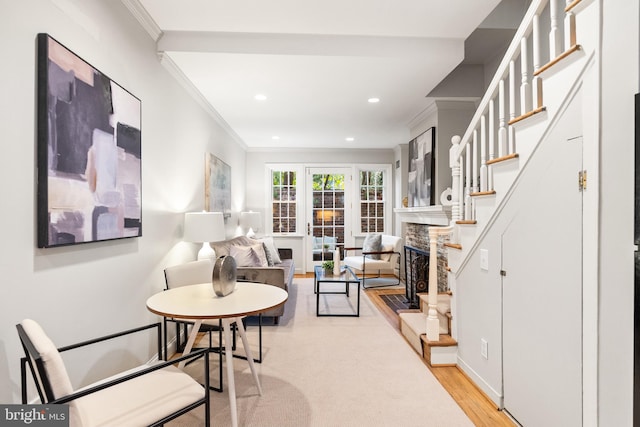 living room featuring light hardwood / wood-style flooring and crown molding