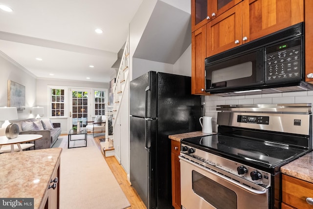 kitchen featuring french doors, backsplash, ornamental molding, black appliances, and light hardwood / wood-style flooring