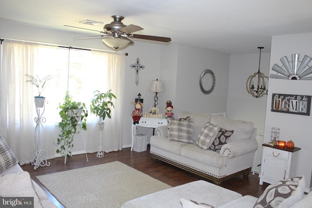 living room with ceiling fan and dark hardwood / wood-style flooring