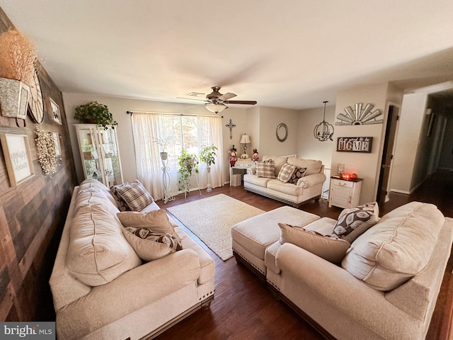 living room with ceiling fan and dark wood-type flooring