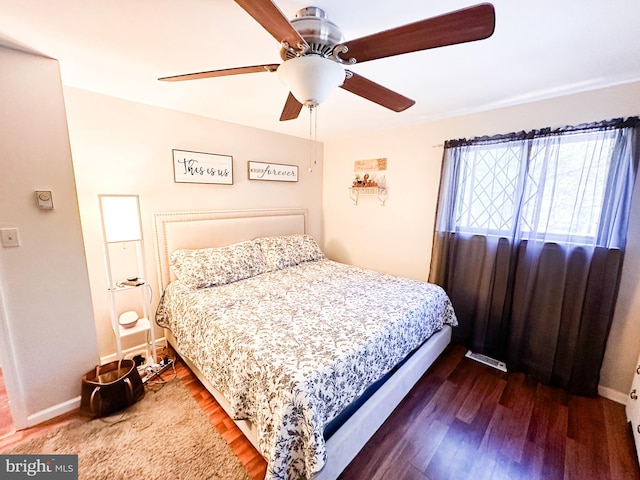 bedroom with dark wood-type flooring and ceiling fan