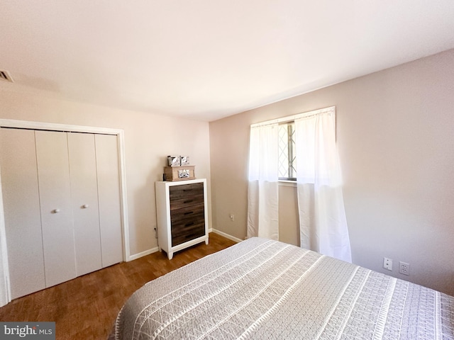 bedroom with hardwood / wood-style flooring and a closet