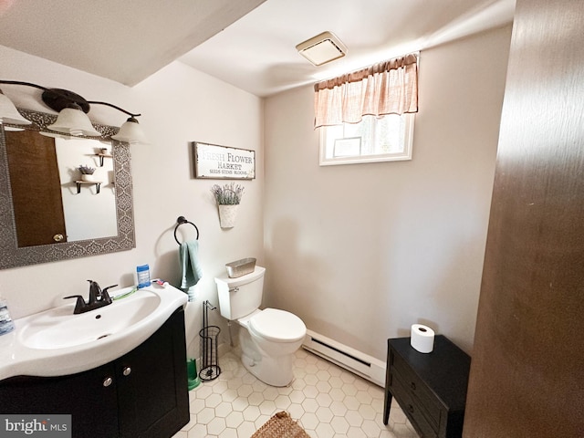 bathroom with toilet, a baseboard heating unit, and vanity