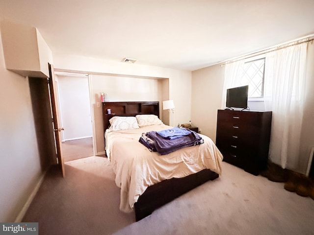 bedroom with light colored carpet