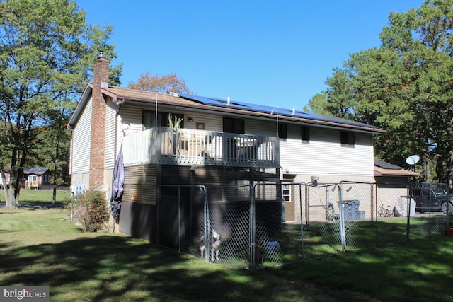 back of house with a yard and a wooden deck