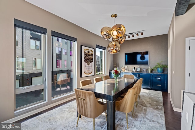 dining space featuring dark wood-type flooring