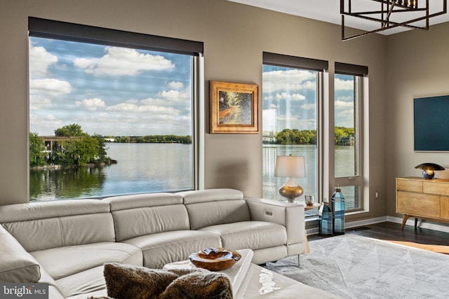 living room with a water view and wood-type flooring