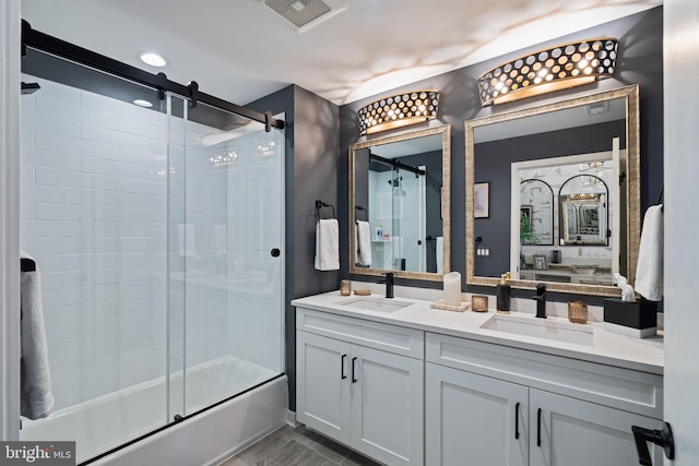 bathroom with combined bath / shower with glass door and vanity