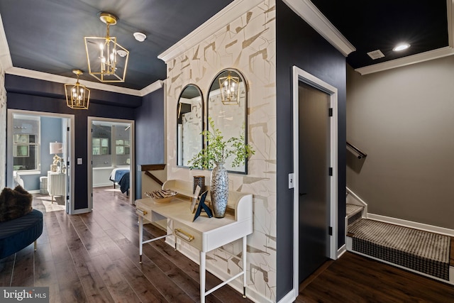 hall featuring a notable chandelier, crown molding, and dark wood-type flooring