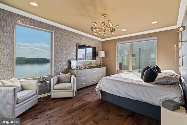 bedroom with ornamental molding, a water view, dark wood-type flooring, and a chandelier