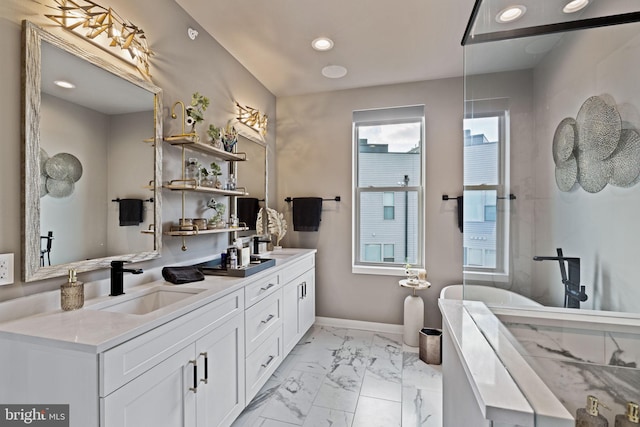 bathroom featuring vanity and a tub to relax in