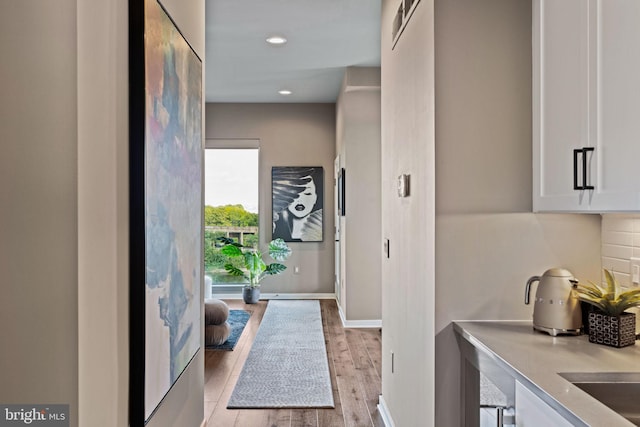 doorway with light wood-type flooring